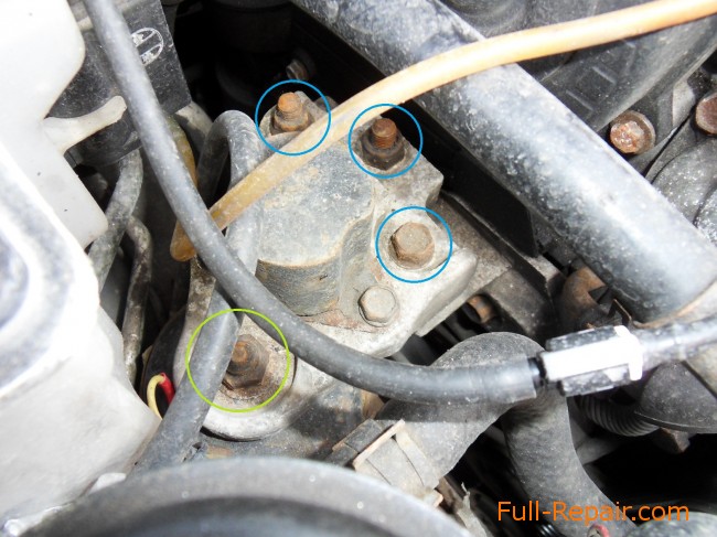 nuts and bolts that hold the engine to the pillow. View from above 